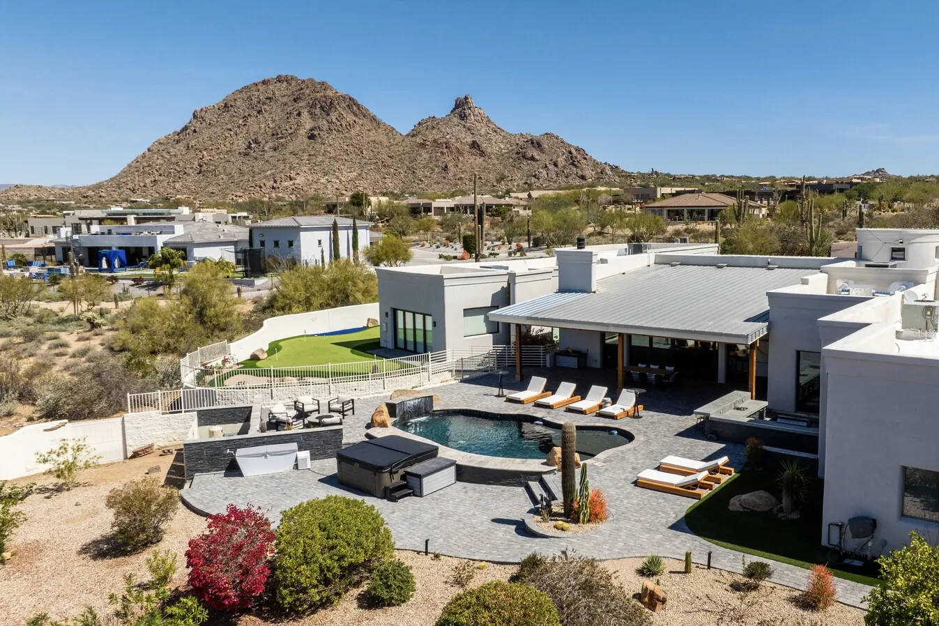 Gray paver pool deck and lounge area with Pinnacle Peak behind, Scottsdale